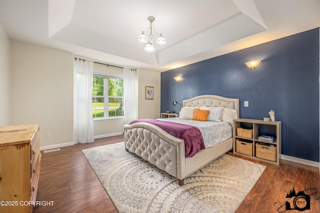 4228 E Serendipity Loop, Wasilla, AK 99654 - bedroom with a raised ceiling, wood finished floors, and a chandelier