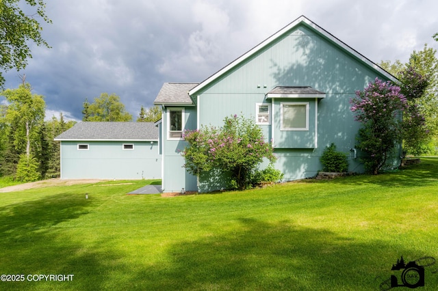 4228 E Serendipity Loop, Wasilla, AK 99654 - view of home's exterior featuring a lawn and roof with shingles