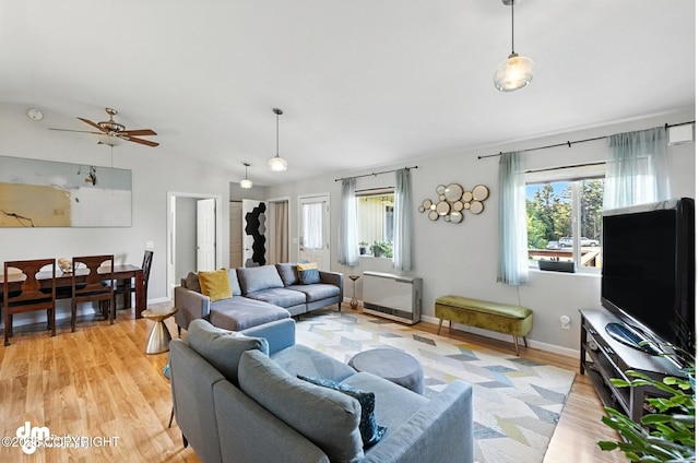 196 W Fairview Ave, Homer, AK 99603 - living room with lofted ceiling, light wood finished floors, a ceiling fan, and heating unit
