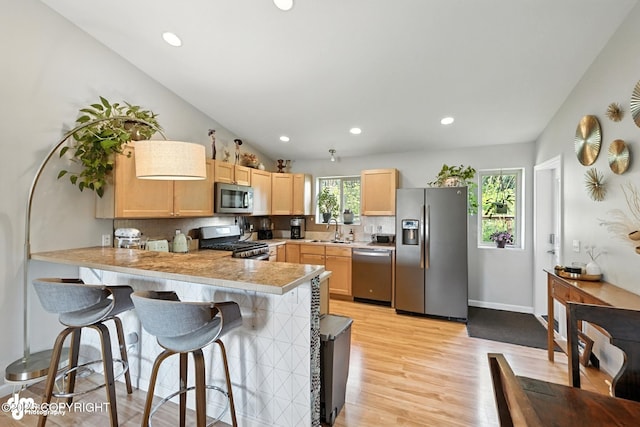 196 W Fairview Ave, Homer, AK 99603 - kitchen with appliances with stainless steel finishes, light brown cabinets, a peninsula, decorative backsplash, and recessed lighting