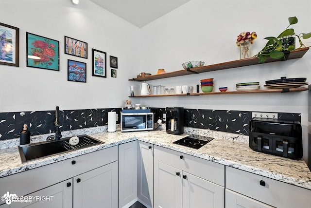 196 W Fairview Ave, Homer, AK 99603 - kitchen featuring stainless steel microwave, open shelves, and light stone counters