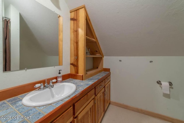 17751 Arcturus Loop, Ninilchik, AK 99639 - bathroom featuring vanity, a textured ceiling, and vaulted ceiling