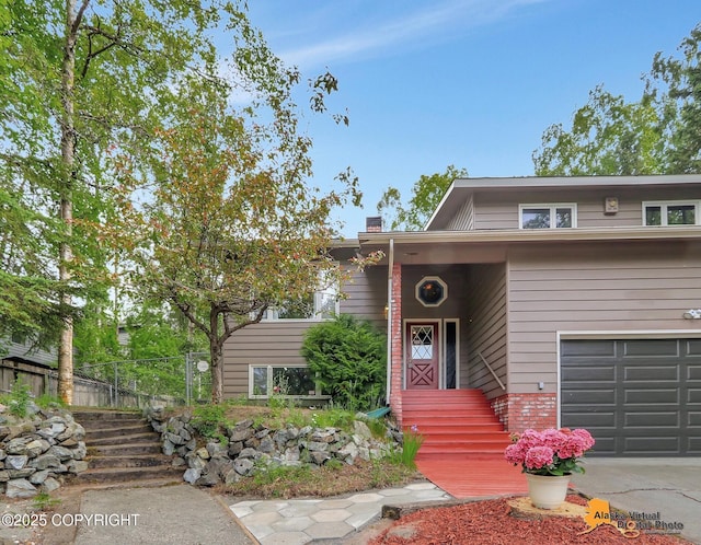 4023 Apollo Dr, Anchorage, AK 99504 - view of front of property with a chimney, an attached garage, and brick siding