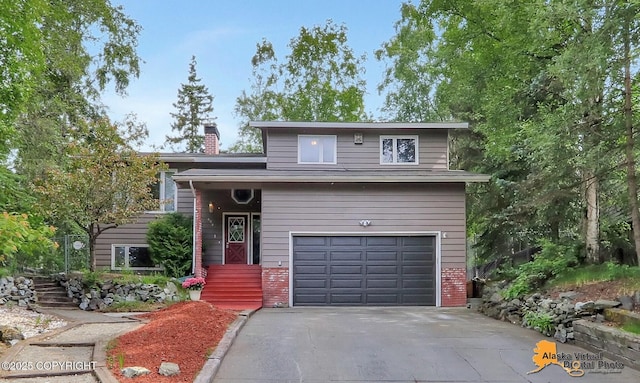 4023 Apollo Dr, Anchorage, AK 99504 - view of front of home featuring an attached garage, a chimney, asphalt driveway, and brick siding