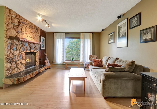 4023 Apollo Dr, Anchorage, AK 99504 - living area with a textured ceiling, wood finished floors, a fireplace, and track lighting