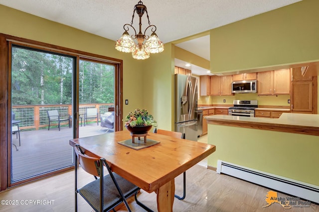 4023 Apollo Dr, Anchorage, AK 99504 - dining area with a baseboard radiator, light wood finished floors, a chandelier, and a textured ceiling