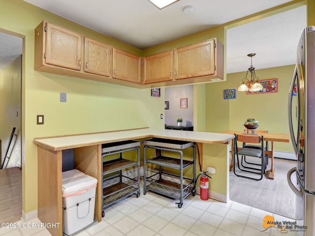 4023 Apollo Dr, Anchorage, AK 99504 - kitchen with freestanding refrigerator, light countertops, hanging light fixtures, and light brown cabinets