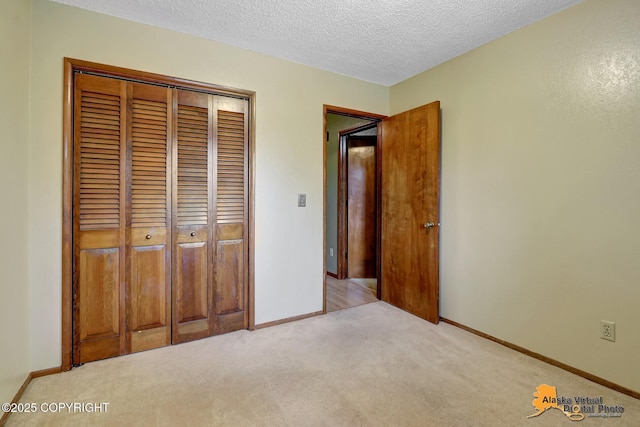 4023 Apollo Dr, Anchorage, AK 99504 - unfurnished bedroom featuring light colored carpet, a closet, and a textured ceiling