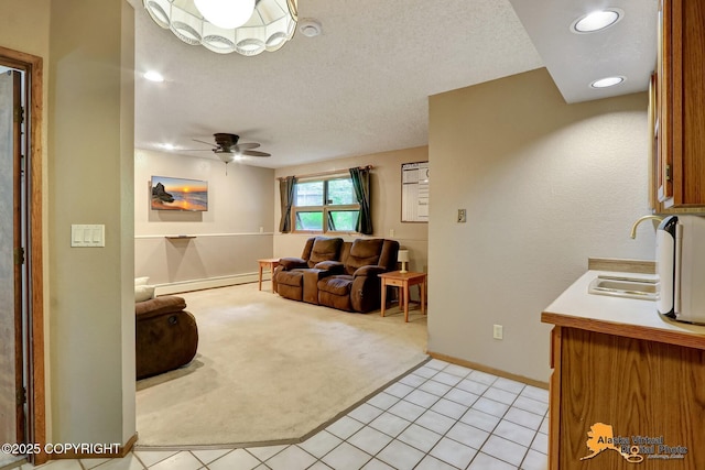 4023 Apollo Dr, Anchorage, AK 99504 - living room featuring baseboard heating, light carpet, ceiling fan, light tile patterned flooring, and a textured ceiling