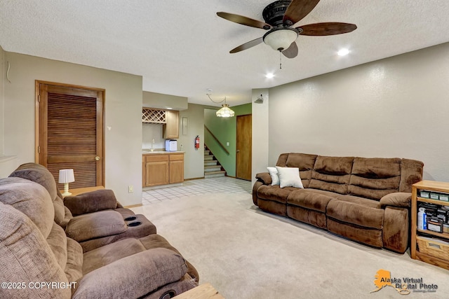 4023 Apollo Dr, Anchorage, AK 99504 - living area with stairs, a textured ceiling, light colored carpet, ceiling fan, and recessed lighting