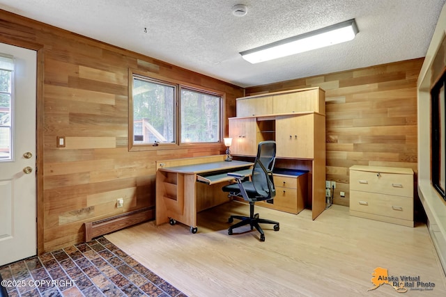4023 Apollo Dr, Anchorage, AK 99504 - office area featuring wooden walls, a textured ceiling, baseboard heating, and wood finished floors