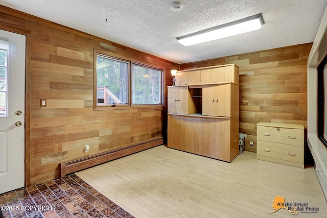 4023 Apollo Dr, Anchorage, AK 99504 - unfurnished bedroom featuring wooden walls, multiple windows, a textured ceiling, and a baseboard radiator