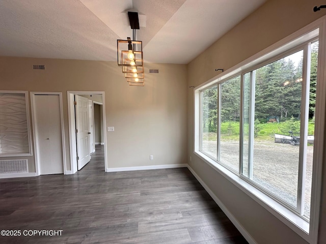 5705 Felix Cir, Homer, AK 99603 - unfurnished dining area with dark wood finished floors and a textured ceiling