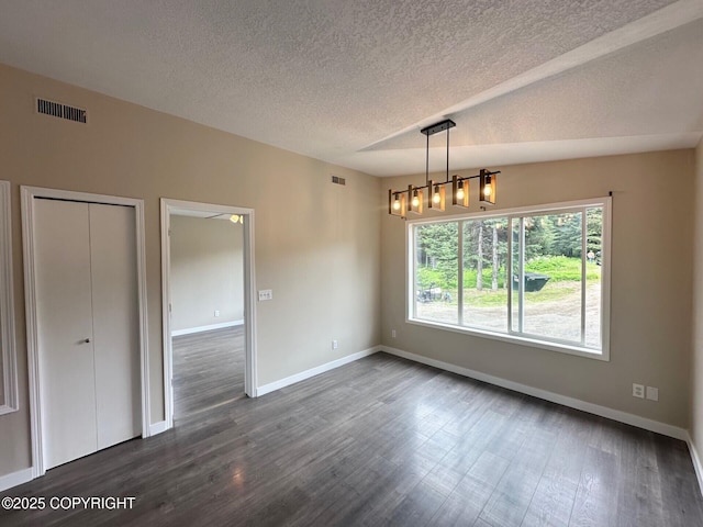 5705 Felix Cir, Homer, AK 99603 - unfurnished dining area featuring dark wood-type flooring and a textured ceiling