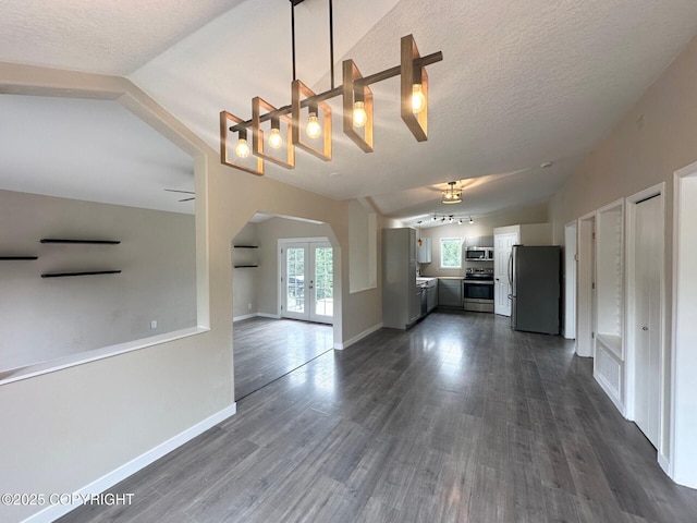 5705 Felix Cir, Homer, AK 99603 - unfurnished living room with arched walkways, french doors, vaulted ceiling, dark wood finished floors, and a chandelier