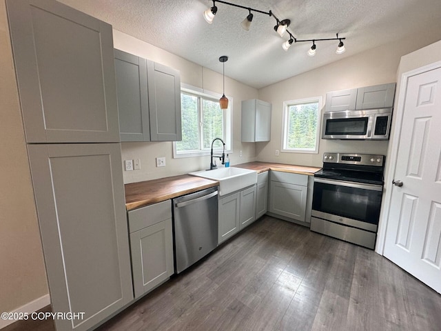 5705 Felix Cir, Homer, AK 99603 - kitchen with stainless steel appliances, dark wood finished floors, gray cabinets, a textured ceiling, and pendant lighting