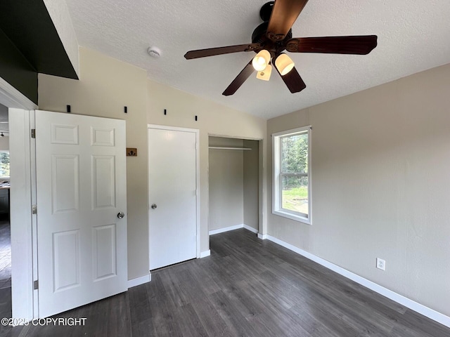 5705 Felix Cir, Homer, AK 99603 - unfurnished bedroom with dark wood-style flooring, a closet, a textured ceiling, and ceiling fan