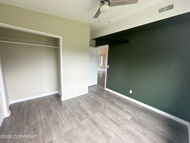 5705 Felix Cir, Homer, AK 99603 - unfurnished bedroom featuring wood finished floors, a closet, and ceiling fan