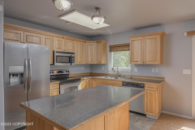 1250 Toolik Dr, North Pole, AK 99705 - kitchen with appliances with stainless steel finishes, light brown cabinetry, a center island, and dark countertops