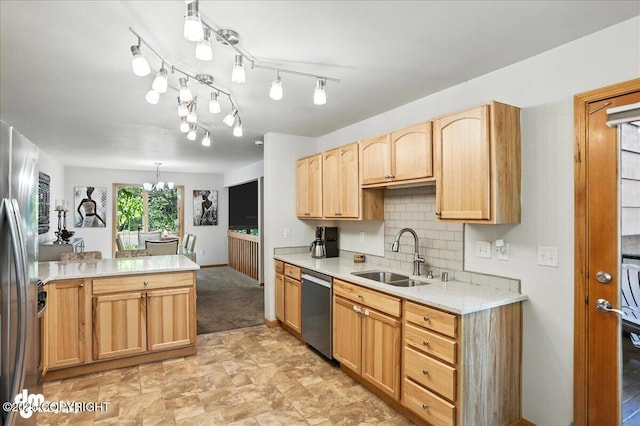 6712 Lunar Dr # K2, Anchorage, AK 99504 - kitchen featuring stainless steel appliances, light countertops, light brown cabinetry, decorative backsplash, and a chandelier