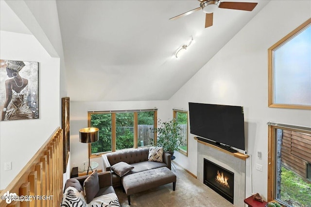 6712 Lunar Dr # K2, Anchorage, AK 99504 - living area with a lit fireplace, lofted ceiling, and ceiling fan