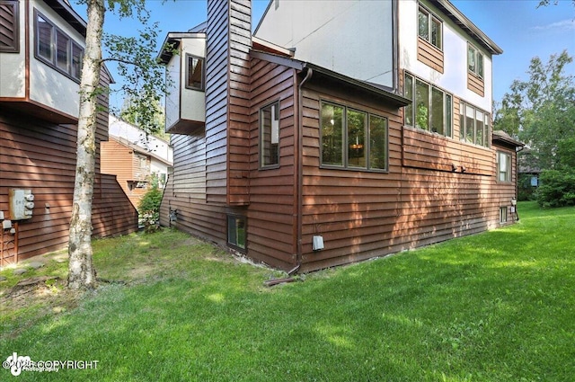 6712 Lunar Dr # K2, Anchorage, AK 99504 - view of side of property with a chimney and a yard