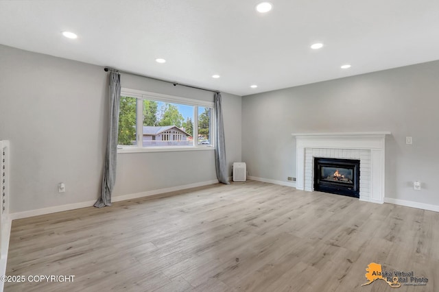 8461 Greenhill Way, Anchorage, AK 99502 - unfurnished living room with recessed lighting, wood finished floors, and a fireplace