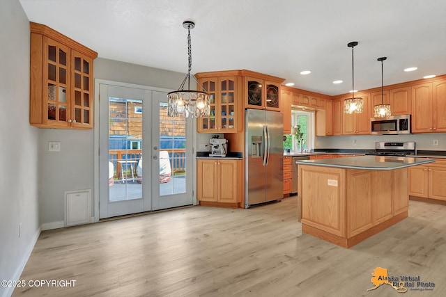 8461 Greenhill Way, Anchorage, AK 99502 - kitchen with appliances with stainless steel finishes, plenty of natural light, recessed lighting, light wood-type flooring, and glass insert cabinets