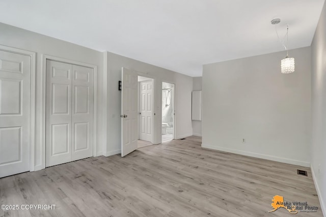 8461 Greenhill Way, Anchorage, AK 99502 - unfurnished living room with baseboards and light wood finished floors
