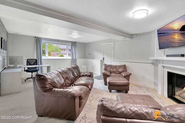 8461 Greenhill Way, Anchorage, AK 99502 - living area featuring a fireplace, a desk, and light wood-style floors