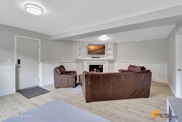 8461 Greenhill Way, Anchorage, AK 99502 - living room with light wood-style flooring and a warm lit fireplace