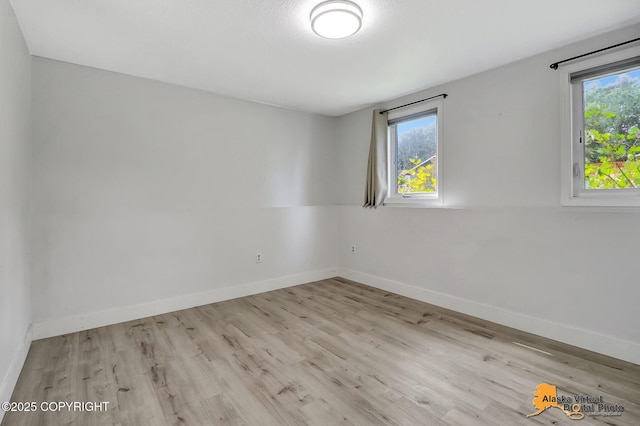 8461 Greenhill Way, Anchorage, AK 99502 - empty room featuring plenty of natural light and wood finished floors