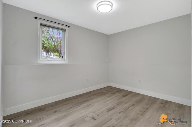 8461 Greenhill Way, Anchorage, AK 99502 - empty room featuring wood finished floors and baseboards