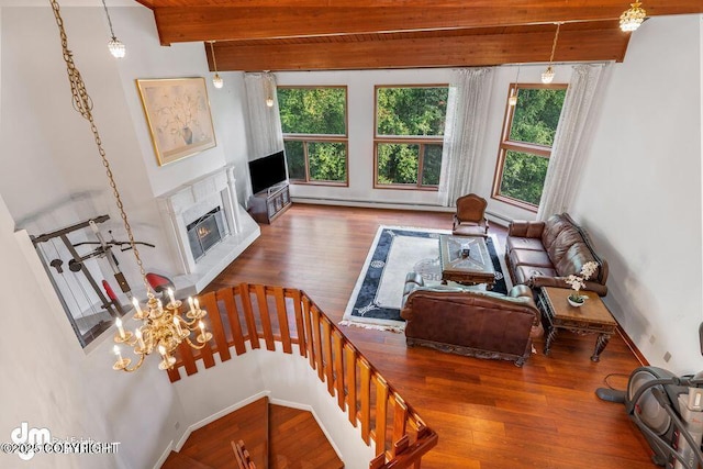 2107 Sorbus Way, Anchorage, AK 99508 - living area with plenty of natural light, beamed ceiling, wood-type flooring, a high end fireplace, and a baseboard heating unit