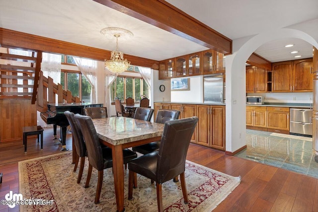 2107 Sorbus Way, Anchorage, AK 99508 - dining room with a chandelier, dark wood finished floors, beamed ceiling, arched walkways, and recessed lighting