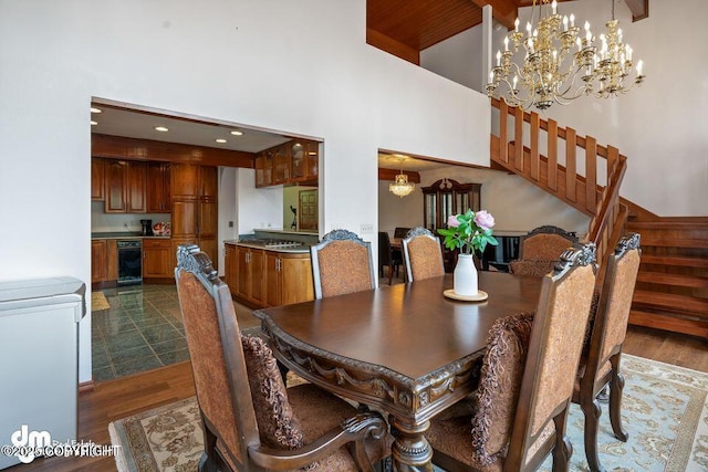 2107 Sorbus Way, Anchorage, AK 99508 - dining room featuring a towering ceiling, dark wood-style floors, stairway, a chandelier, and recessed lighting