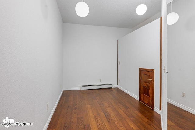2107 Sorbus Way, Anchorage, AK 99508 - empty room with a baseboard heating unit and wood finished floors