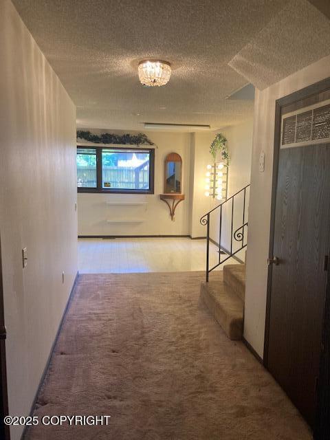 2531 W 79th Ave, Anchorage, AK 99502 - corridor featuring carpet flooring, stairs, and a textured ceiling