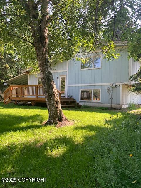 2531 W 79th Ave, Anchorage, AK 99502 - back of house featuring a deck and a yard