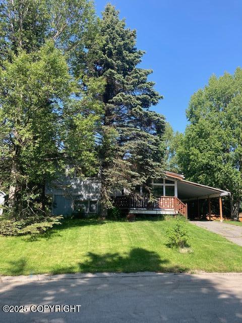 2531 W 79th Ave, Anchorage, AK 99502 - view of front of home with driveway, an attached carport, and a front yard