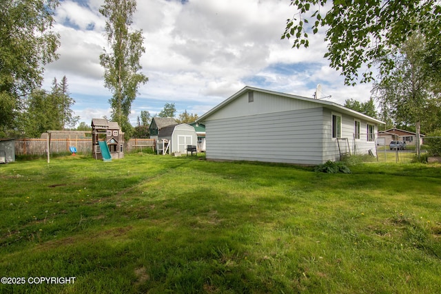 1119 Alder Ave, Kenai, AK 99611 - view of yard with a playground and a shed