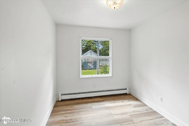 173 W Corral Ave, Soldotna, AK 99669 - spare room featuring a baseboard heating unit and wood finished floors