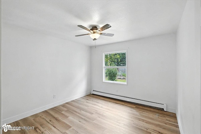 173 W Corral Ave, Soldotna, AK 99669 - unfurnished room with a baseboard radiator, light wood-style flooring, and ceiling fan