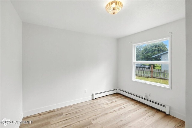 173 W Corral Ave, Soldotna, AK 99669 - spare room with light wood-type flooring and a baseboard radiator