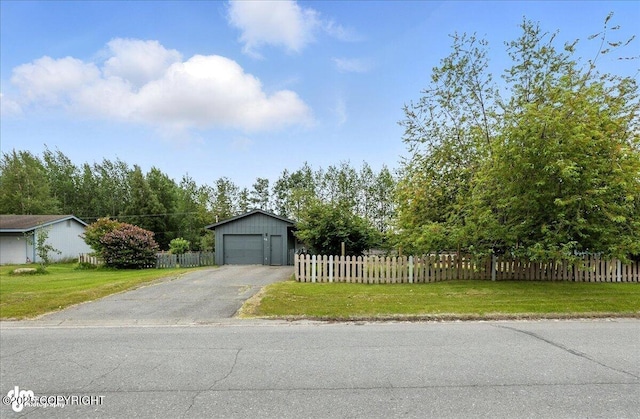 173 W Corral Ave, Soldotna, AK 99669 - view of front of property featuring asphalt driveway, an outbuilding, and a garage
