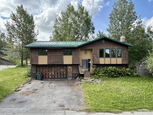 8204 E 17th Ave, Anchorage, AK 99504 - bi-level home with an attached garage, driveway, a front yard, a metal roof, and a chimney