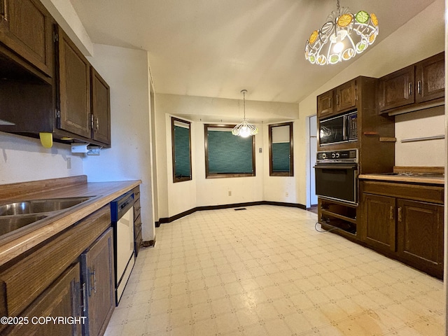 8204 E 17th Ave, Anchorage, AK 99504 - kitchen featuring black appliances, light floors, dark brown cabinets, decorative light fixtures, and a chandelier