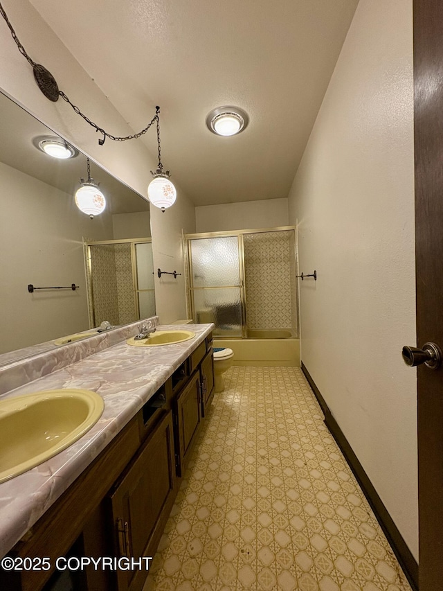 8204 E 17th Ave, Anchorage, AK 99504 - bathroom featuring double vanity, combined bath / shower with glass door, and tile patterned floors