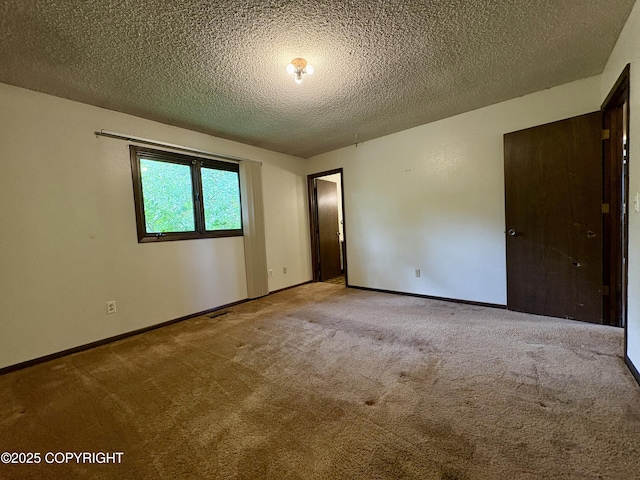 8204 E 17th Ave, Anchorage, AK 99504 - carpeted empty room featuring a textured ceiling and baseboards