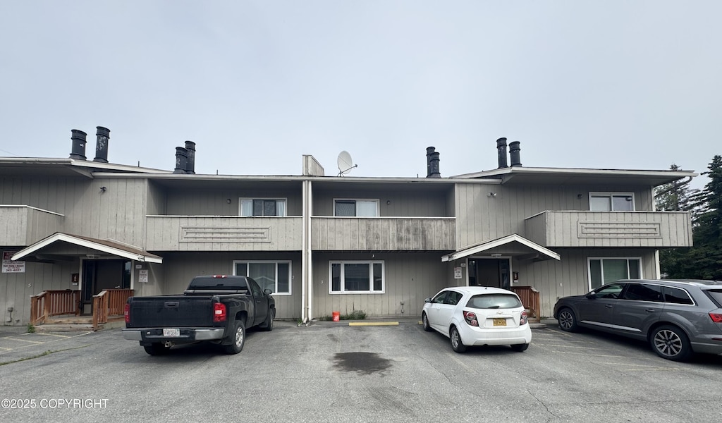 7068 Weimer Rd # 3, Anchorage, AK 99502 - view of front of home featuring a balcony and uncovered parking